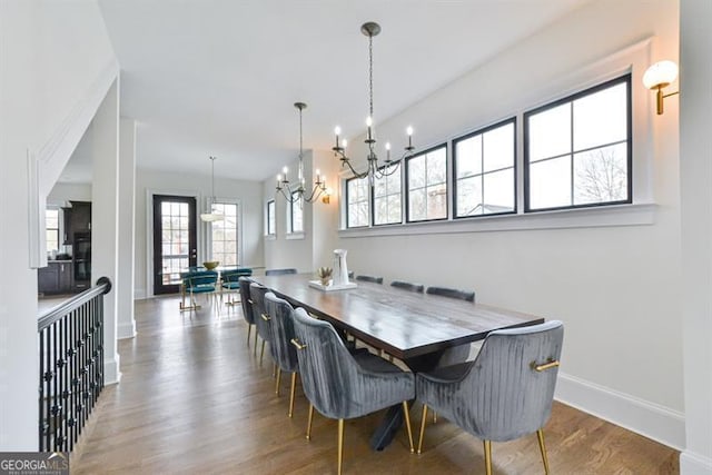 dining room with hardwood / wood-style flooring and a notable chandelier