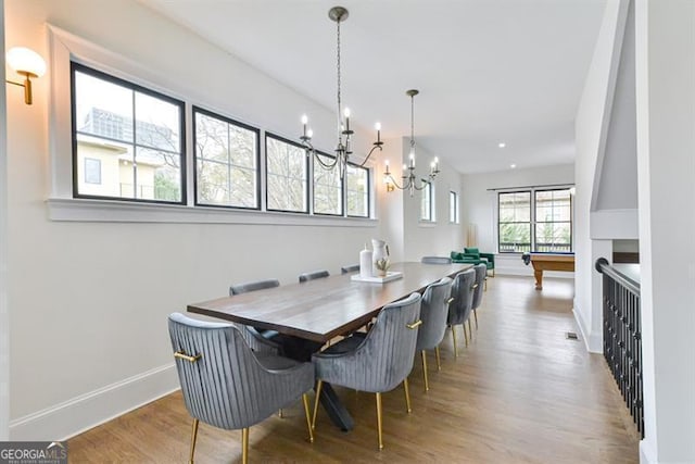 dining space featuring an inviting chandelier and hardwood / wood-style flooring