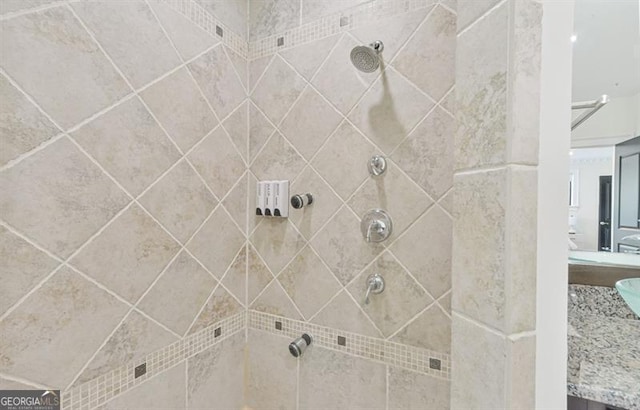 bathroom with vanity and tiled shower