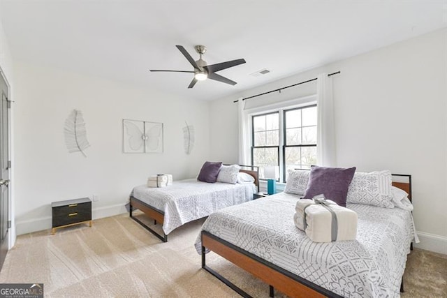 bedroom featuring light carpet and ceiling fan