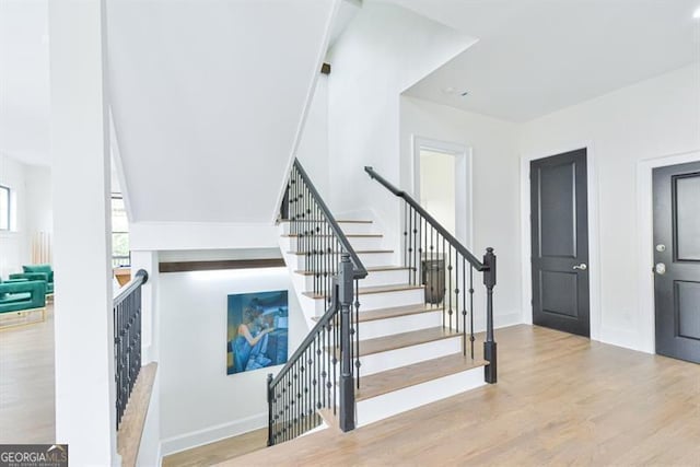 staircase featuring wood-type flooring