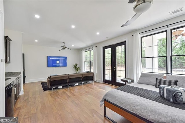 bedroom featuring french doors, ceiling fan, access to exterior, and light hardwood / wood-style flooring