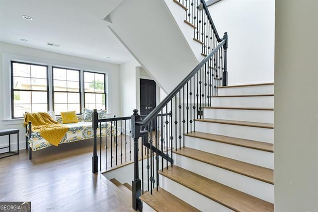 stairway featuring hardwood / wood-style floors