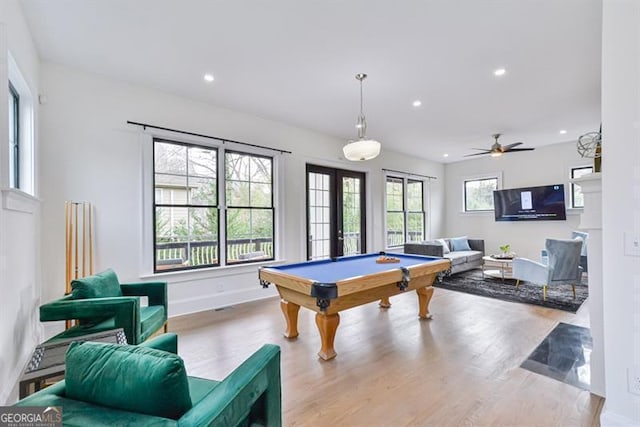 recreation room with pool table, light hardwood / wood-style floors, and french doors