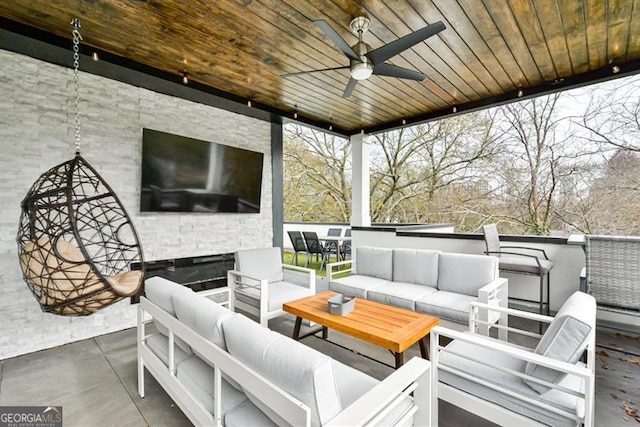 wooden terrace featuring a patio area, outdoor lounge area, and ceiling fan