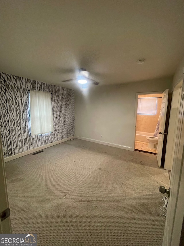 carpeted empty room featuring ceiling fan