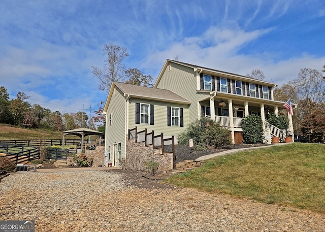 view of front of home with a porch and a front yard