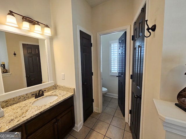 bathroom with vanity, tile patterned floors, and toilet