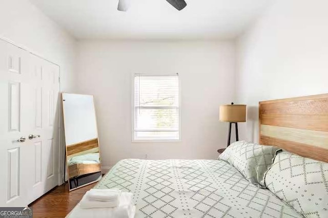 bedroom featuring dark wood-type flooring and ceiling fan