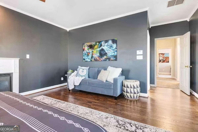 living room with crown molding and hardwood / wood-style flooring