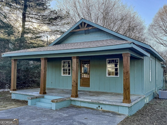 view of front of house with cooling unit and covered porch