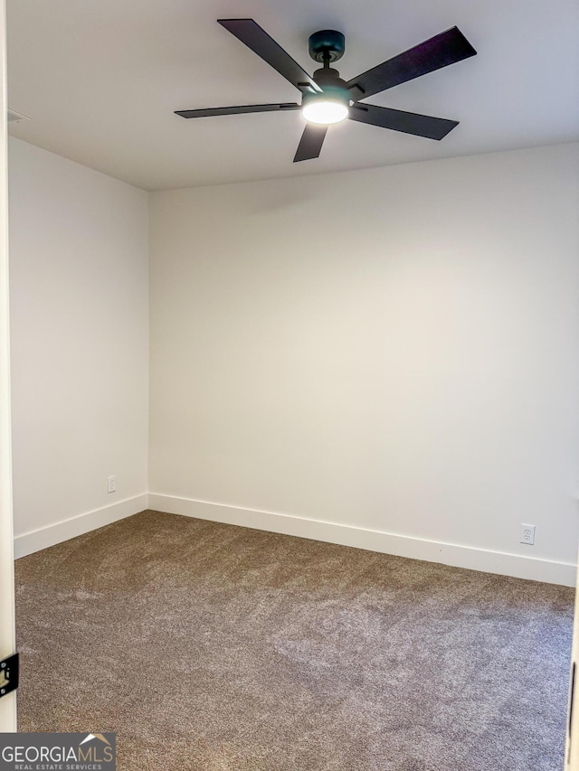 carpeted empty room featuring ceiling fan