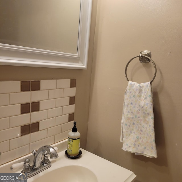 bathroom featuring tasteful backsplash and sink