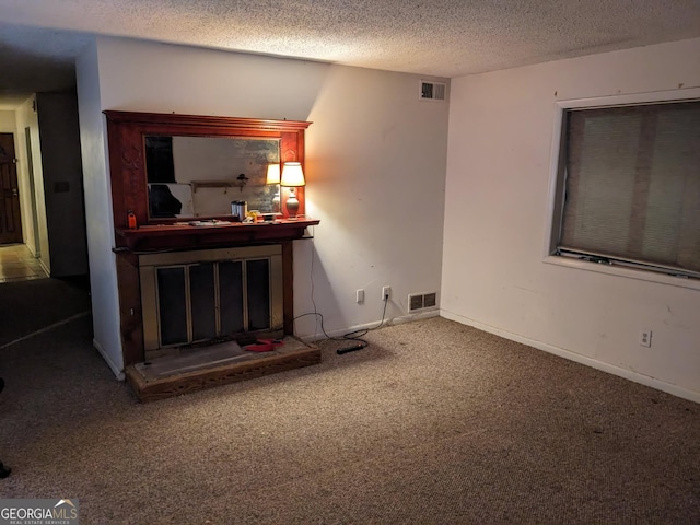 carpeted living room with a textured ceiling