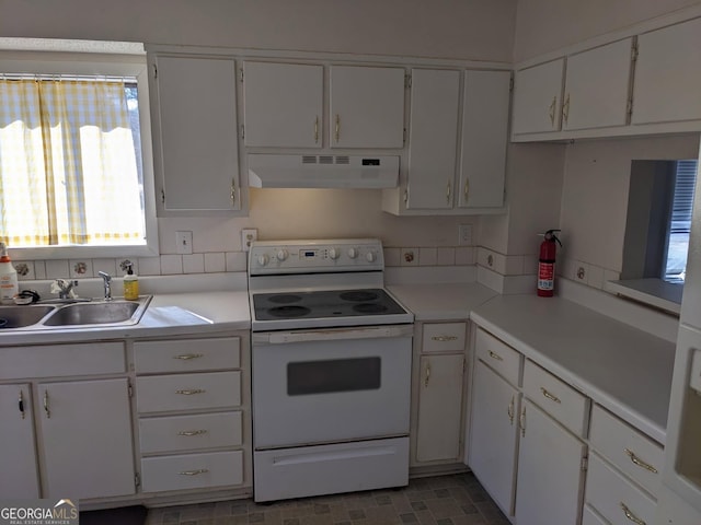 kitchen with white cabinets, sink, and electric range