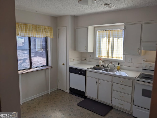 kitchen featuring dishwashing machine, white electric range, and white cabinets