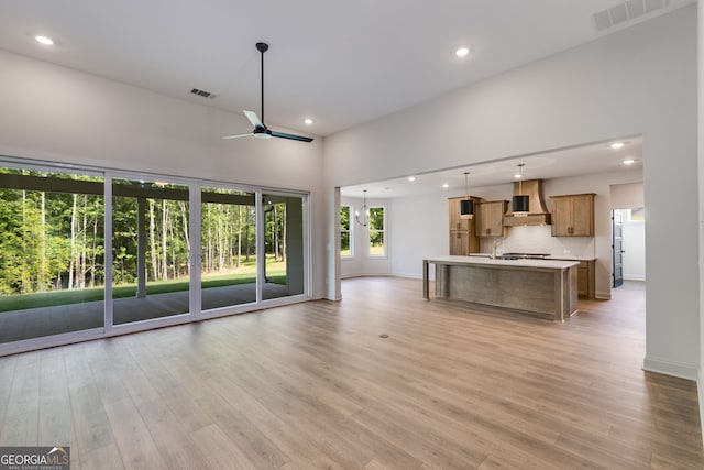 1593 Bethesda Church Rd, Carrollton, GA 30117 - unfurnished living room with ceiling fan, recessed lighting, baseboards, light wood-type flooring, and a high ceiling