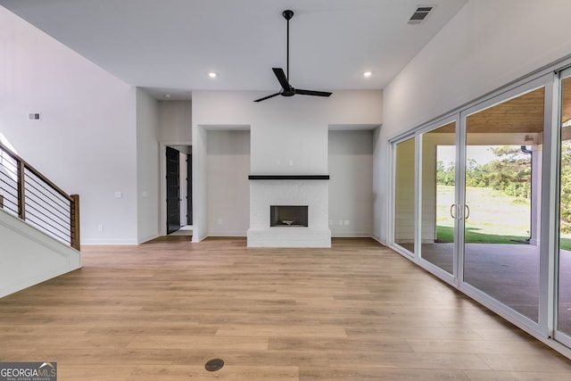 1593 Bethesda Church Rd, Carrollton, GA 30117 - unfurnished living room featuring ceiling fan, light wood-type flooring, baseboards, recessed lighting, and a fireplace