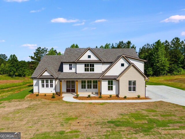 1593 Bethesda Church Rd, Carrollton, GA 30117 - modern inspired farmhouse with concrete driveway, a shingled roof, a front lawn, and covered porch