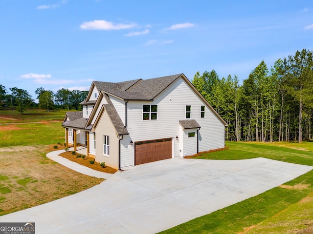 1593 Bethesda Church Rd, Carrollton, GA 30117 - view of home's exterior featuring an attached garage, concrete driveway, a yard, and roof with shingles