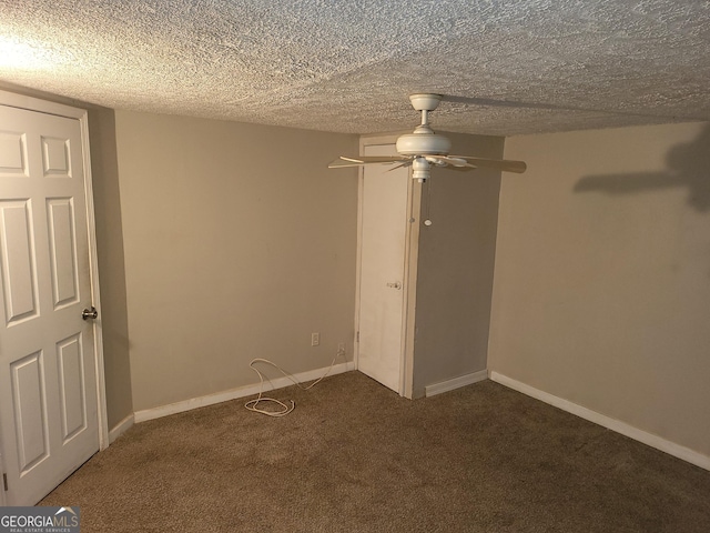 carpeted spare room with ceiling fan and a textured ceiling