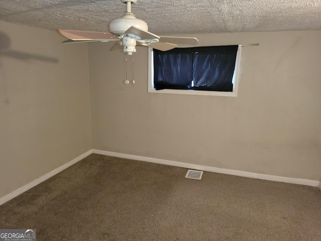 unfurnished room featuring ceiling fan, carpet, and a textured ceiling