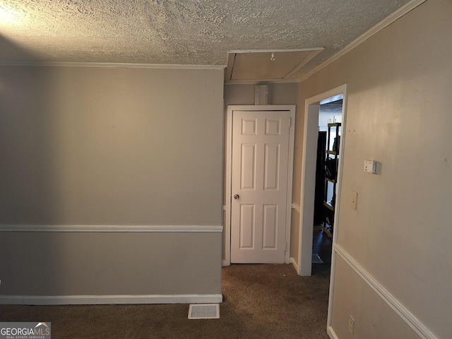 hallway featuring crown molding, a textured ceiling, and dark carpet