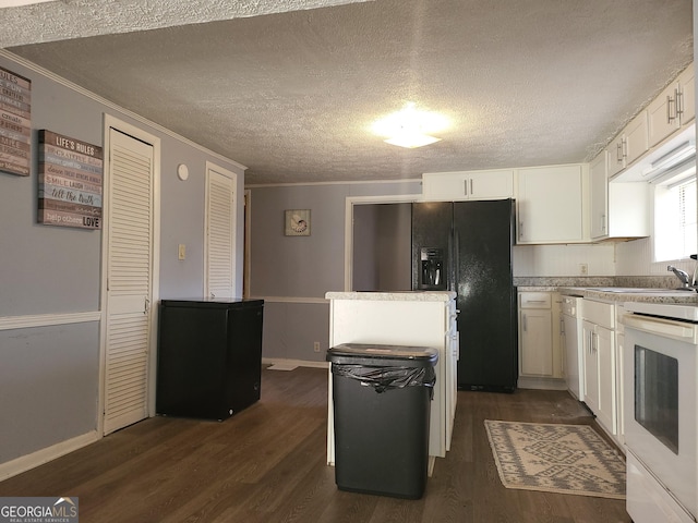 kitchen featuring white cabinetry, ornamental molding, dark hardwood / wood-style floors, and stove