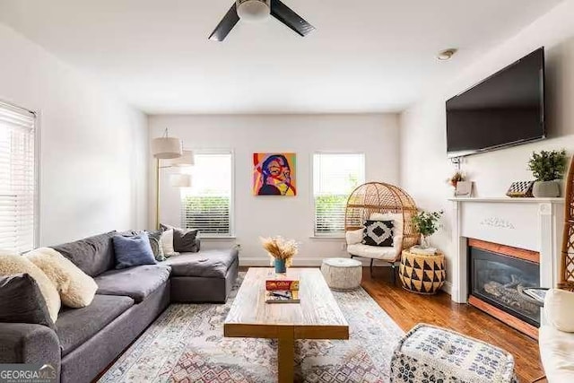 living room with ceiling fan and light hardwood / wood-style flooring