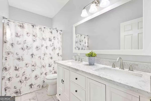 bathroom featuring vanity, curtained shower, and toilet