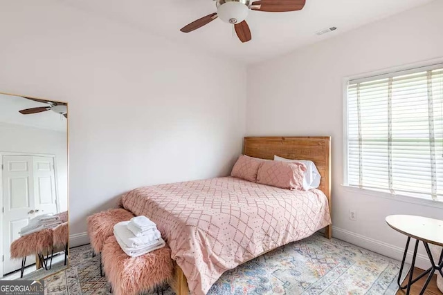 bedroom featuring multiple windows and ceiling fan