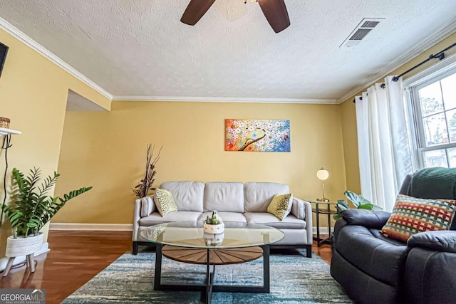 living room with crown molding, wood-type flooring, a textured ceiling, and ceiling fan