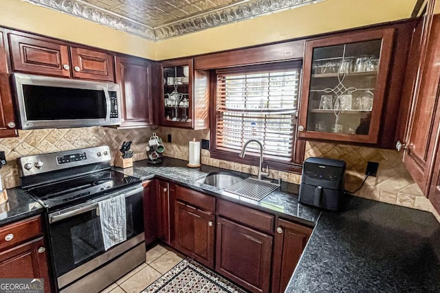 kitchen featuring tasteful backsplash, appliances with stainless steel finishes, and sink