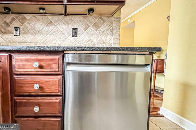 kitchen with stainless steel dishwasher, backsplash, and light tile patterned floors