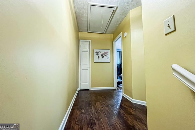 hall featuring dark hardwood / wood-style floors and a textured ceiling