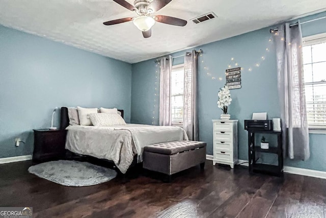 bedroom with dark wood-type flooring and ceiling fan