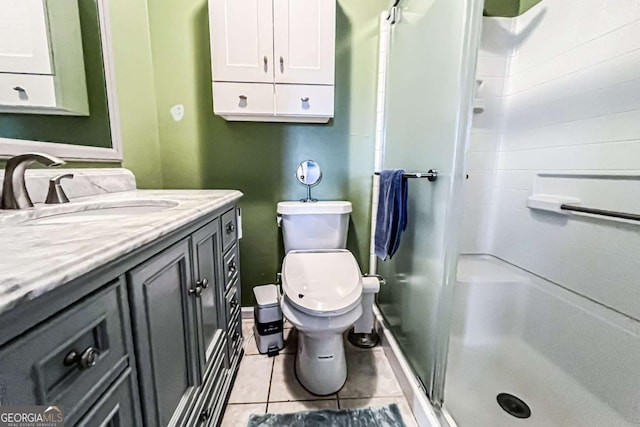 bathroom with toilet, vanity, tile patterned floors, and walk in shower