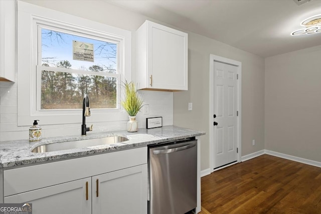 kitchen featuring sink, white cabinets, dark hardwood / wood-style flooring, stainless steel dishwasher, and light stone countertops