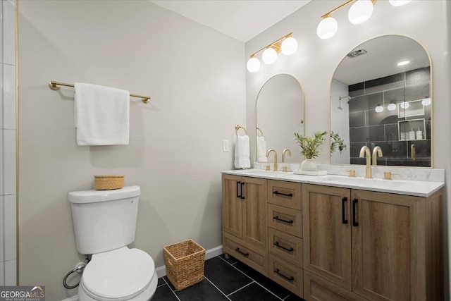 bathroom with vanity, tile patterned floors, and toilet