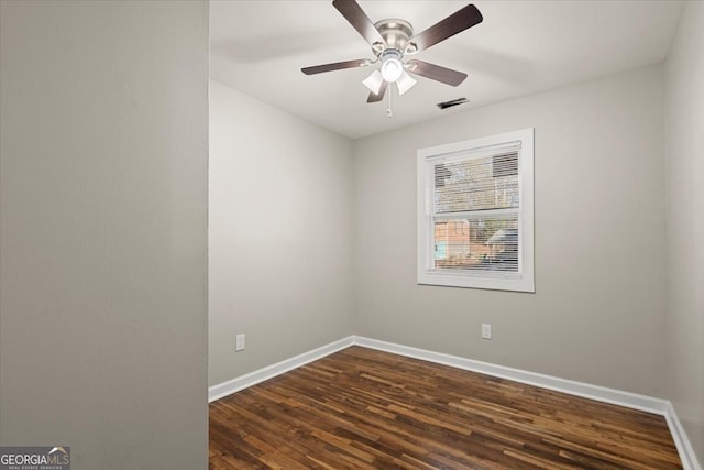 empty room with ceiling fan and dark hardwood / wood-style flooring