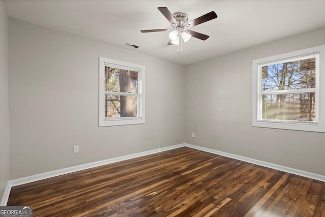 unfurnished room with dark hardwood / wood-style flooring and ceiling fan