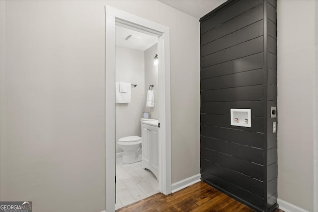 bathroom featuring vanity, hardwood / wood-style floors, and toilet