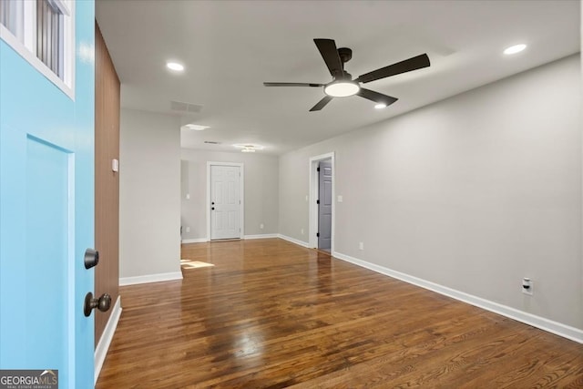 empty room with dark wood-type flooring and ceiling fan