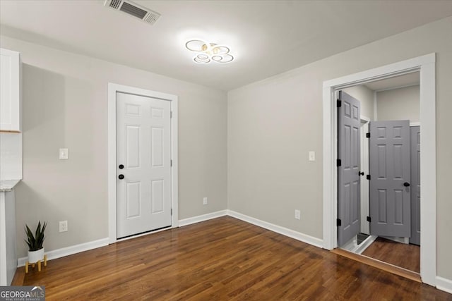 empty room featuring dark hardwood / wood-style flooring