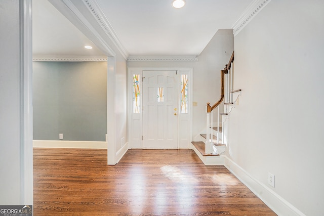 foyer featuring hardwood / wood-style floors and crown molding