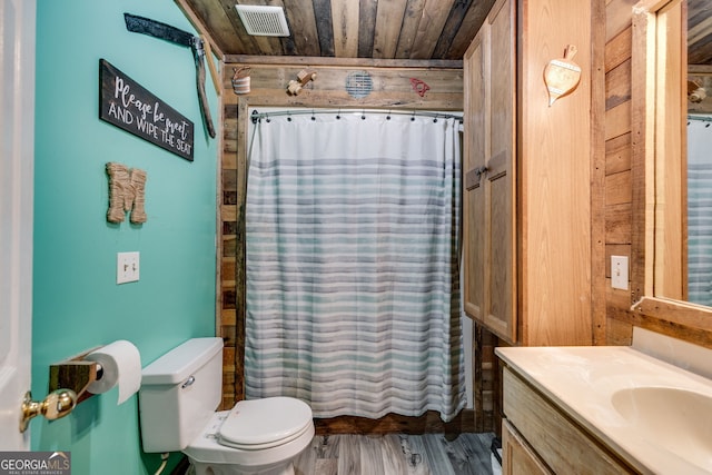 bathroom with toilet, wood walls, wooden ceiling, vanity, and hardwood / wood-style floors