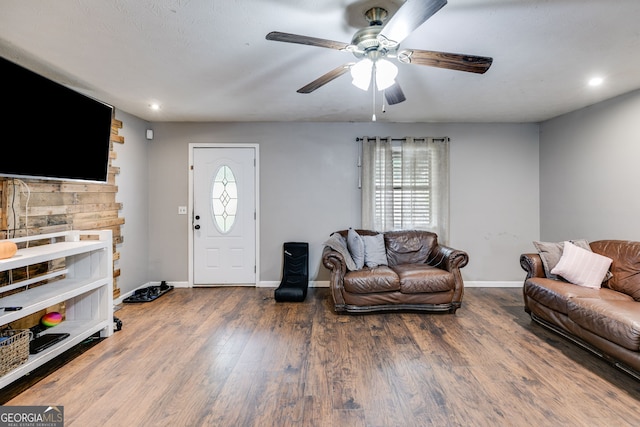 living room featuring hardwood / wood-style flooring and ceiling fan