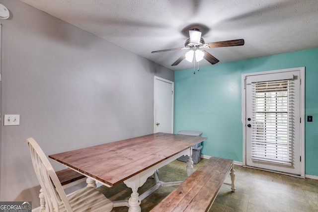 dining room featuring ceiling fan and a textured ceiling