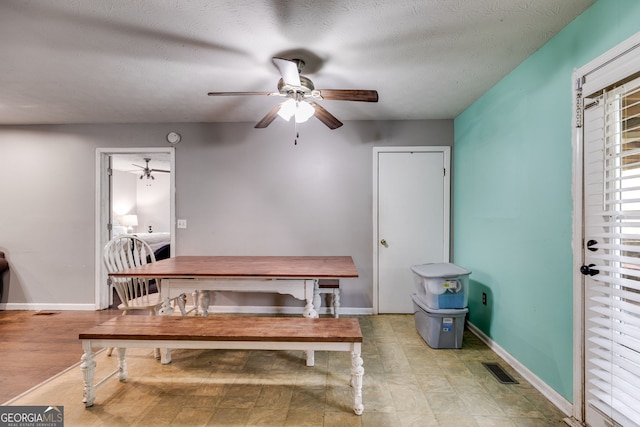 interior space featuring ceiling fan and a textured ceiling