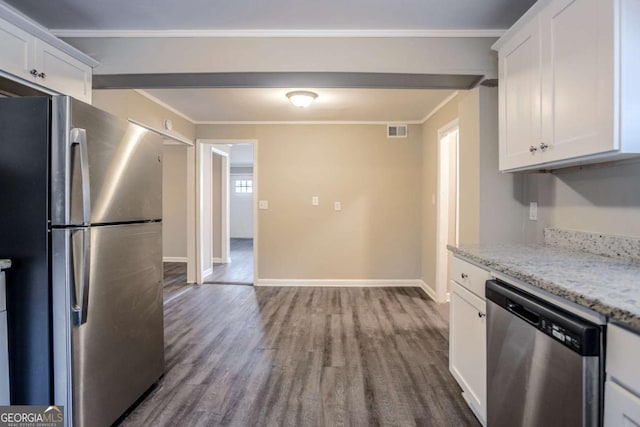 kitchen with stainless steel appliances, hardwood / wood-style floors, white cabinets, and light stone counters